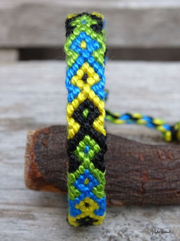 Knüpfe dir Freundschaftsbänder in vier Farben wie hier das Fischmuster in Schwarz, Grün, Gelb und Blau.