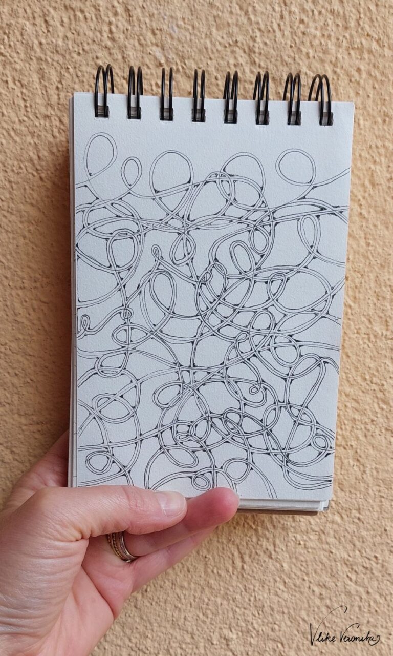 Zeichne Spiralen mit schwarzem Fineliner in deinen Kritzelblock.